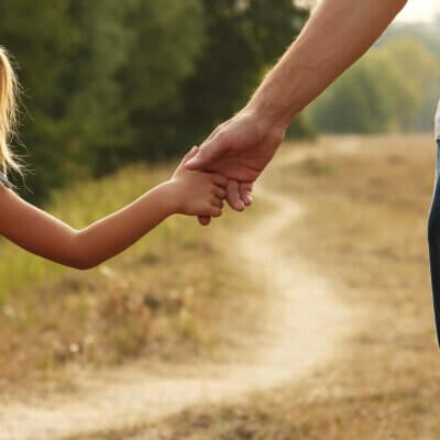 Father holding daughter's hand developing co-regulation.