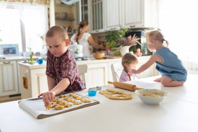 children with her mother preparing cookies independent children large family. casual lifestyle photo series in real life interior learning Nurturing independence with autism