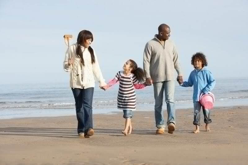 Black family on a beach...summer vacation with kids with ASD