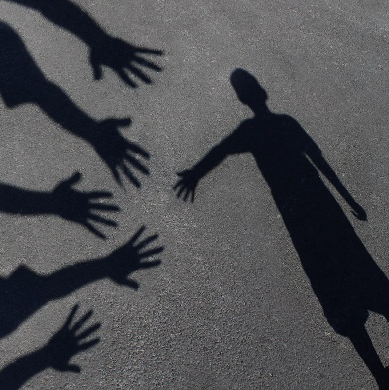 Therapy. A shadow of a child reaching for other hands to help