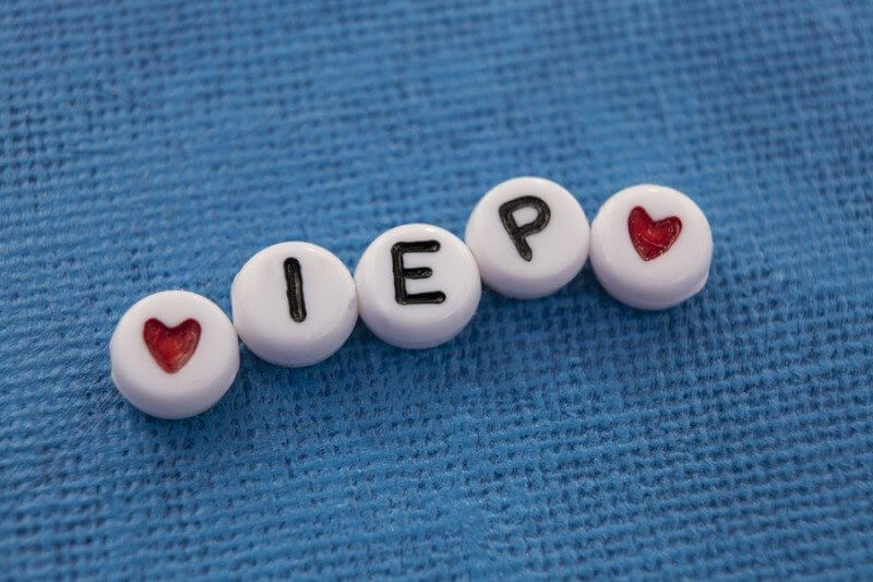 Craft beads spelling out Individualized Education Plan (IEP). A plan used by public schools to support children with special needs and disabilities.