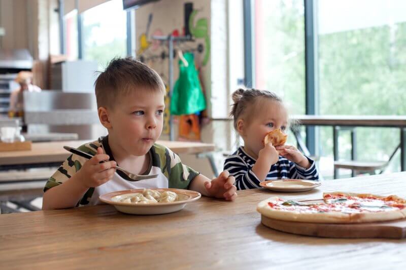 Two kids eating pizza...how to make gluten free dairy free choices for kids with autism