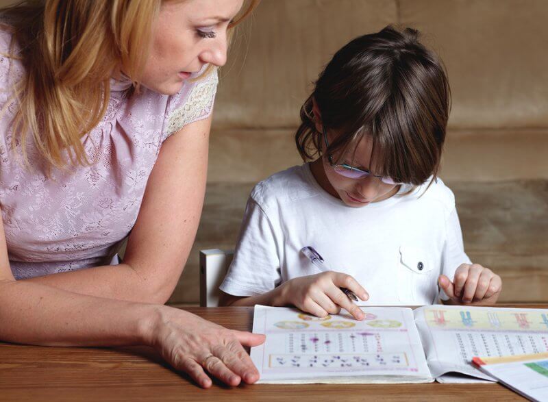 Mother helps her son to do homework