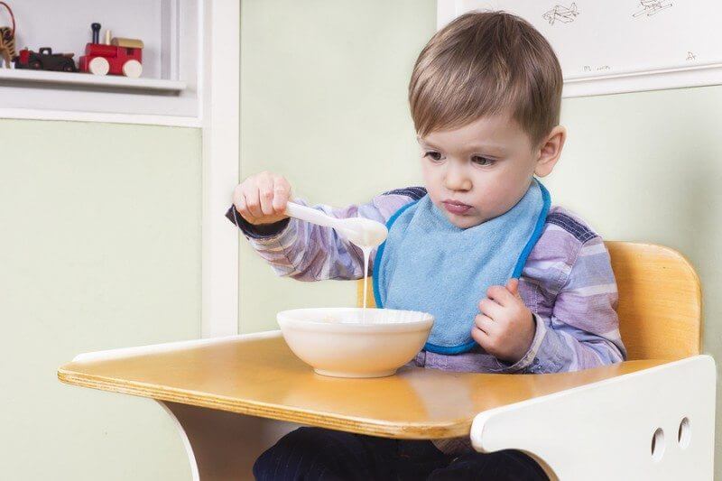 Toddler looking at his food with no appetite