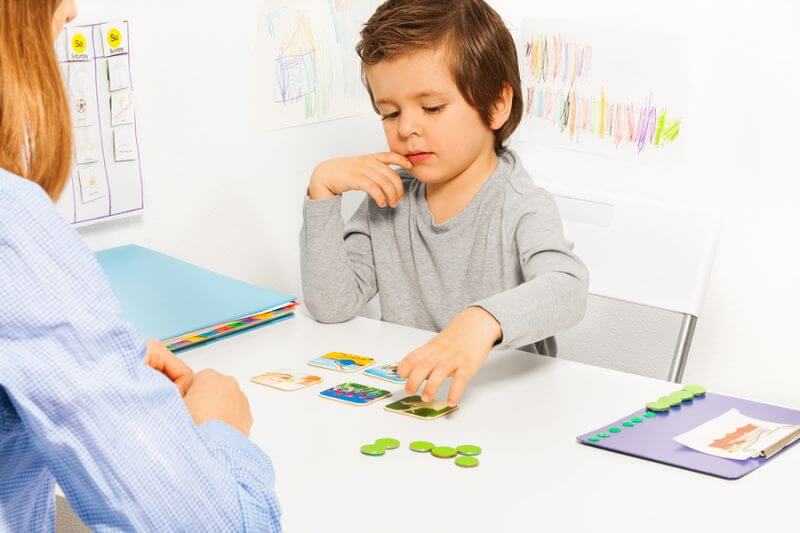 Young boy with autism getting therapy