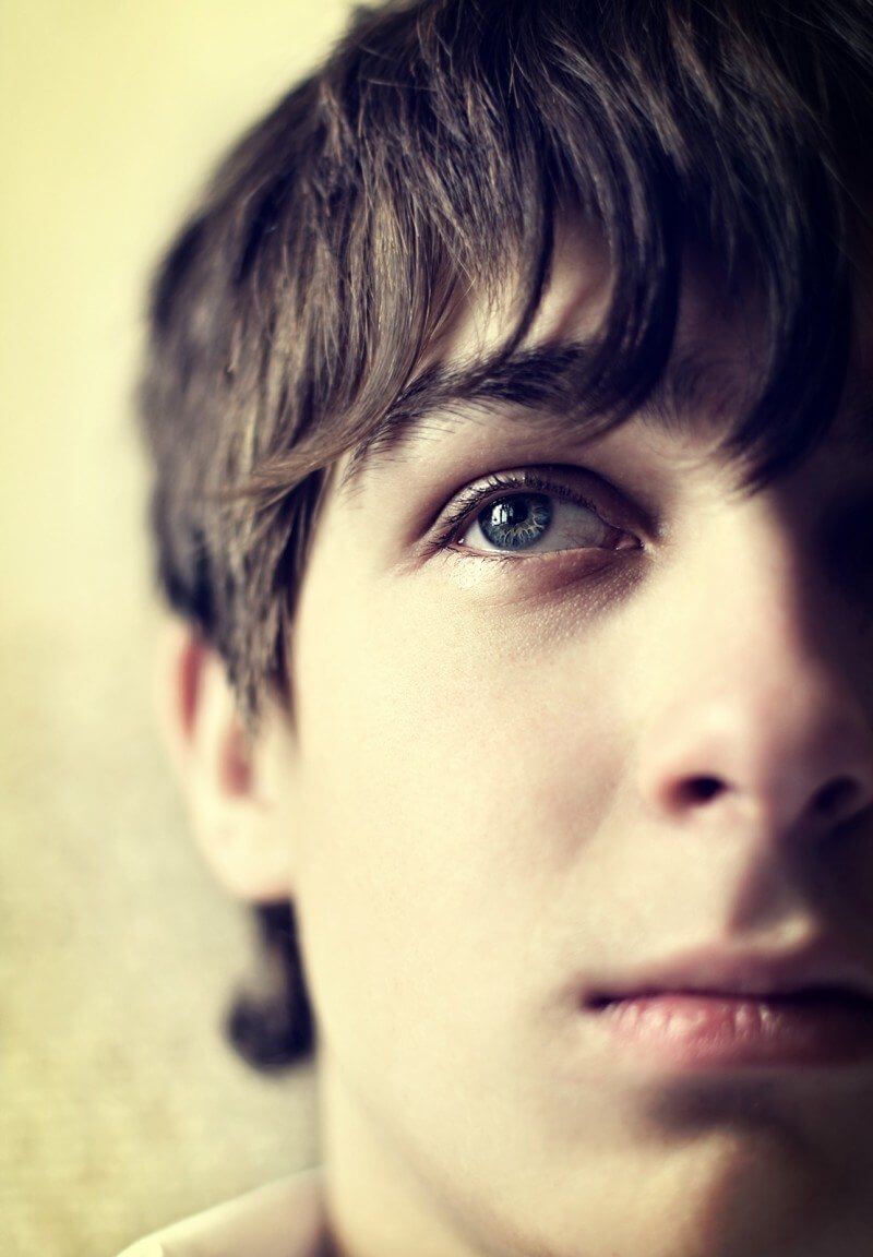 Toned Photo of Sad Teenager with anxiety Face closeup with Focus on an Eye