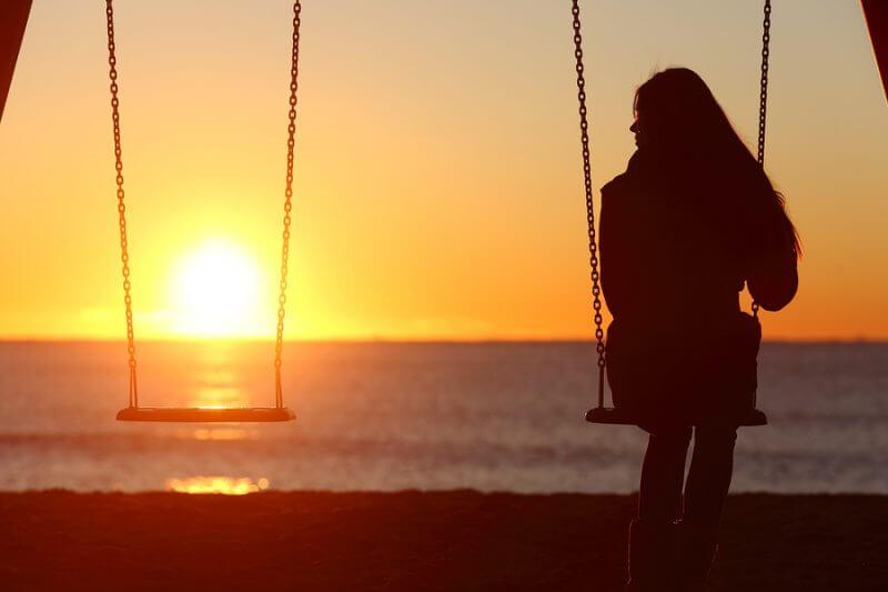 Single Woman Alone Swinging On The Beach Estate Planning for your child with disabillites