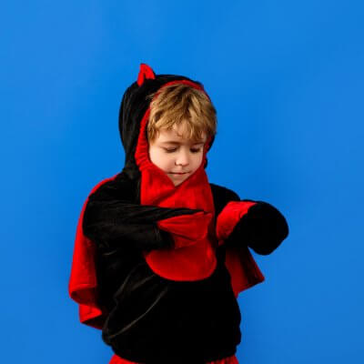 Tips for Parents of Children with Autism during Halloween: a small boy in a dragon costume