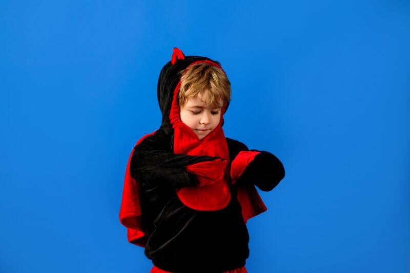 Tips for Parents of Children with Autism during Halloween: a small boy in a dragon costume